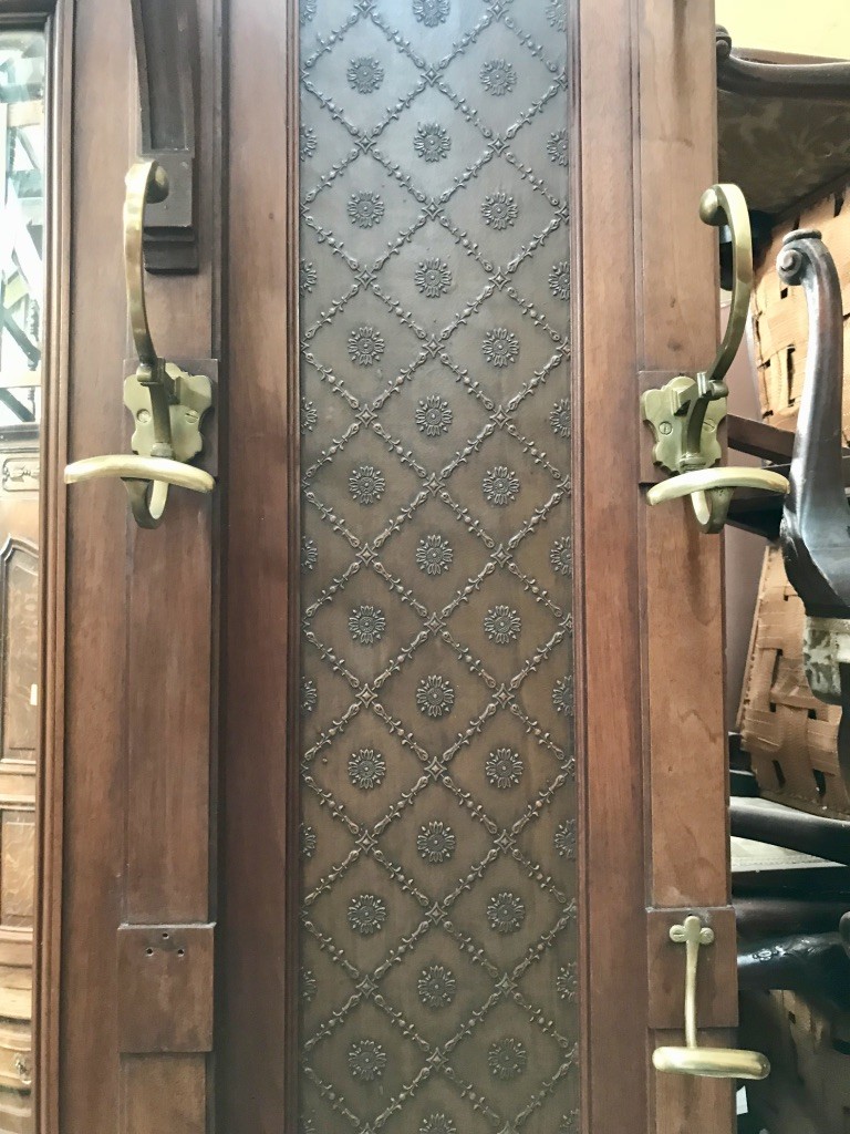 Large French 19th century walnut & pressed metal panelled hall stand with bronze hooks and mirror back.