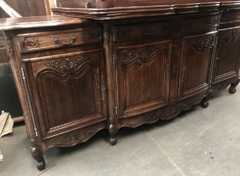 French provincial oak four door buffet with floral carving.