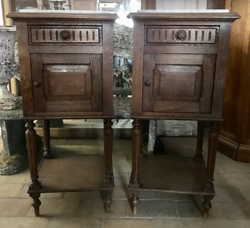 Pair of French oak and white marble top bedside cabinets.