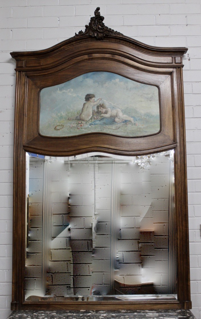 Fine French late 19th century Louis XVth walnut trumeau wall mirror with hand painted cupid decorated panel above.