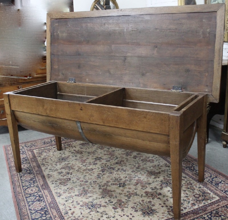 19th century French oak kitchen table having square tapering legs. The top lifts up to reveal dough bin compartment.