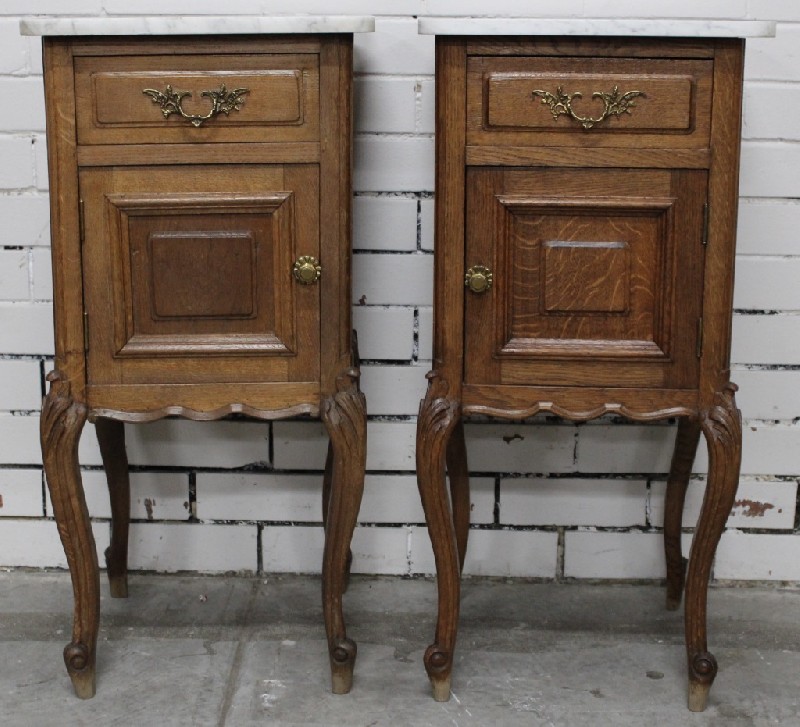 Pair of French provincial oak 1 door bedside cabinets with white marble tops.