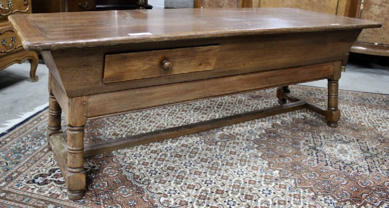 French country oak coffee table with stretcher base and two drawers.