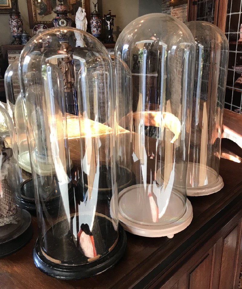 Collection of antique French glass domes on stand.