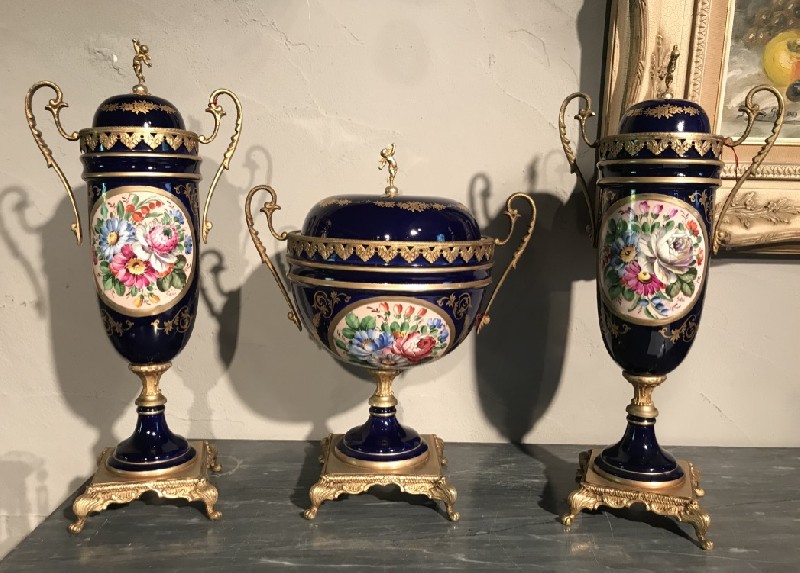Three piece French Sevres style porcelain and brass mounted garniture vase set.