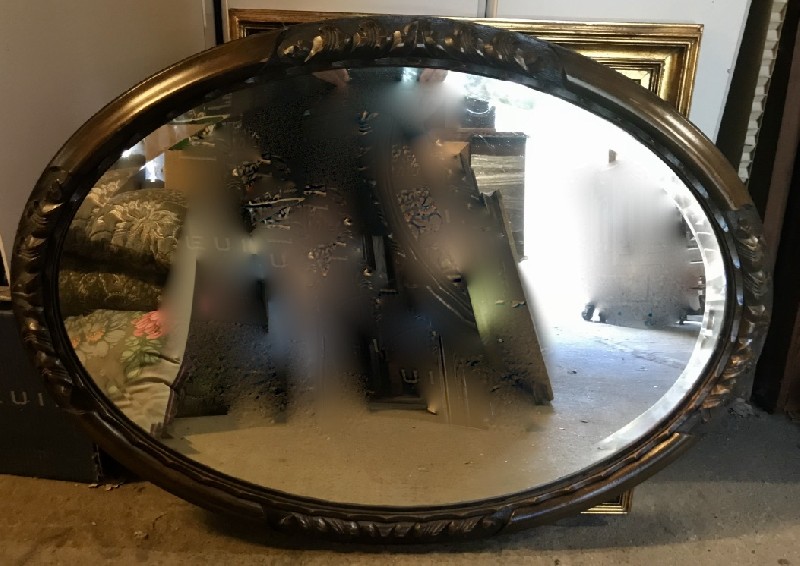 Oval carved walnut wall mirror