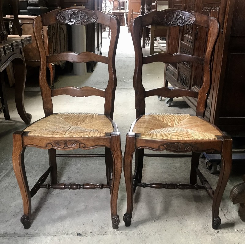 Set of six French oak ladder back chairs with rush seats.