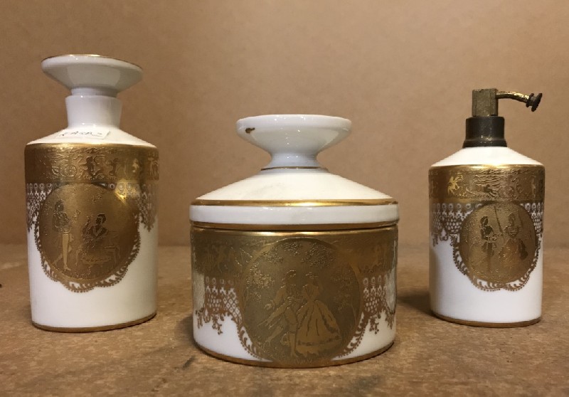3 piece French gilt decorated perfume bottle set.
