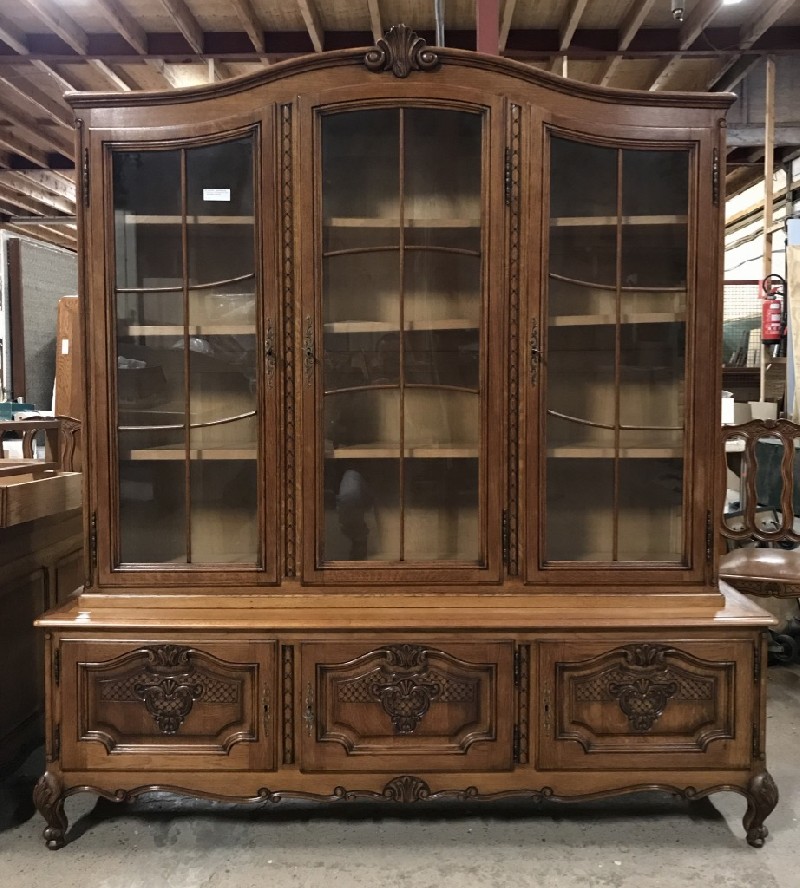 French provincial oak three door display bookcase vitrene, with floral carved panelled doors.