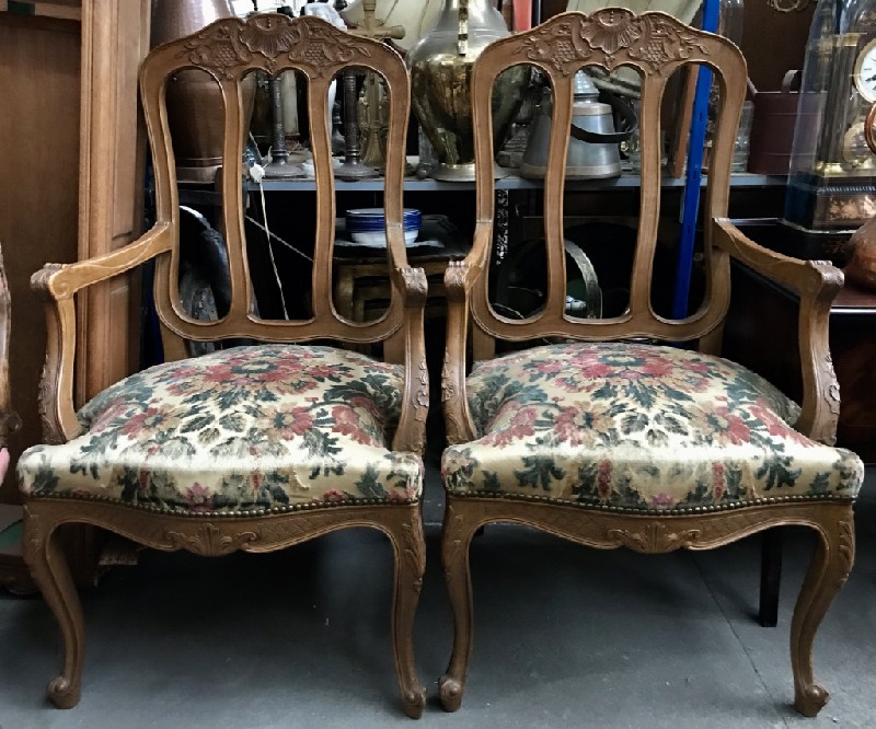 Pair of French Louis XVth carved oak arm carver chairs with floral upholstery.