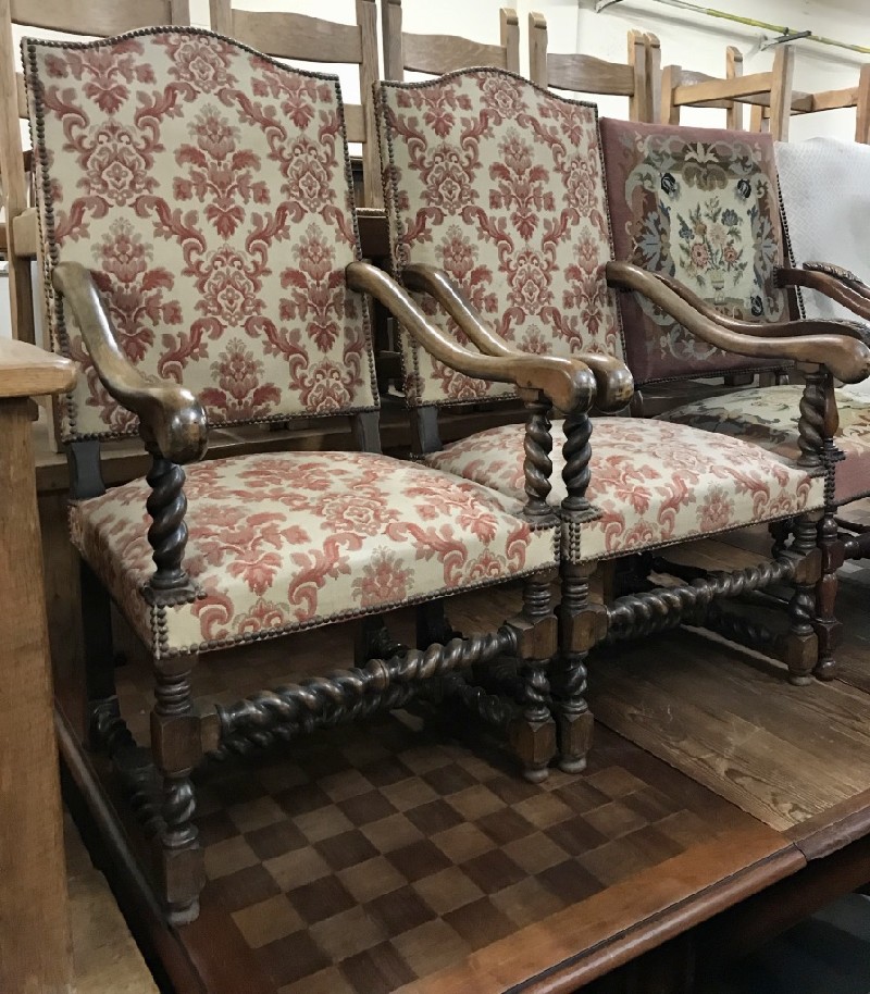 Pair of French provincial oak fauteuil arm chairs with red & white floral upholstery.