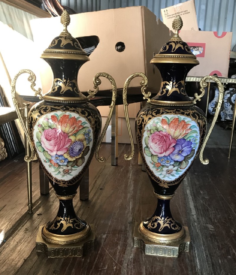 Fine pair of mid-20th century French Sevres style porcelain vases with hand painted floral panels having bronze handles and base.