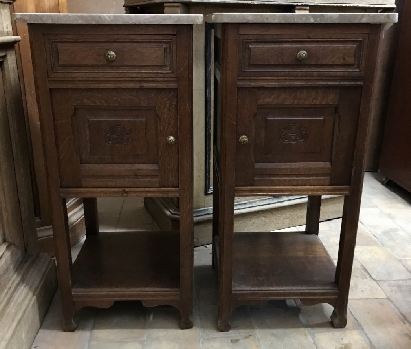 Pair of French oak bedside cabinets with brown marble tops.