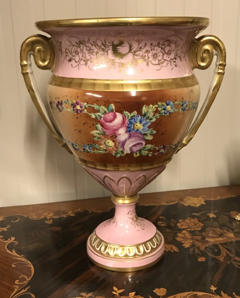 Fine French pink porcelain & gilt decorated 2 handled vase with floral handprinted panels.