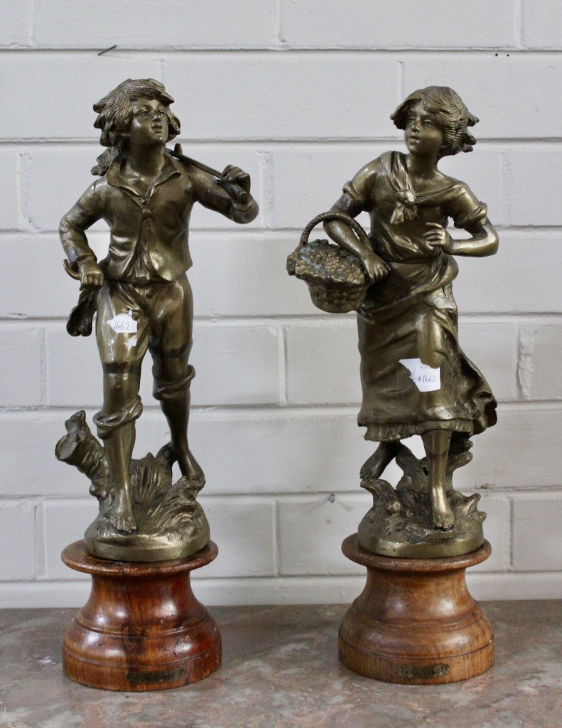 Pair of French early 20th century bronze young boy and maiden figures on wooden bases.