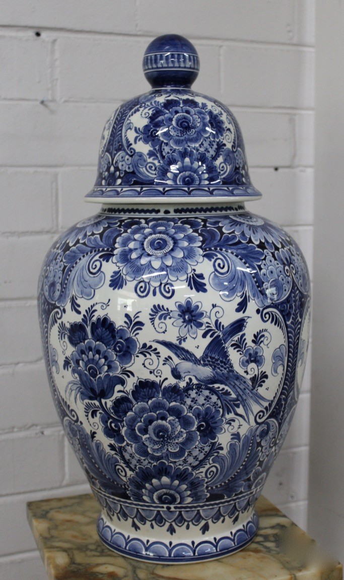 Tall Delft blue and white floral porcelain covered vase.