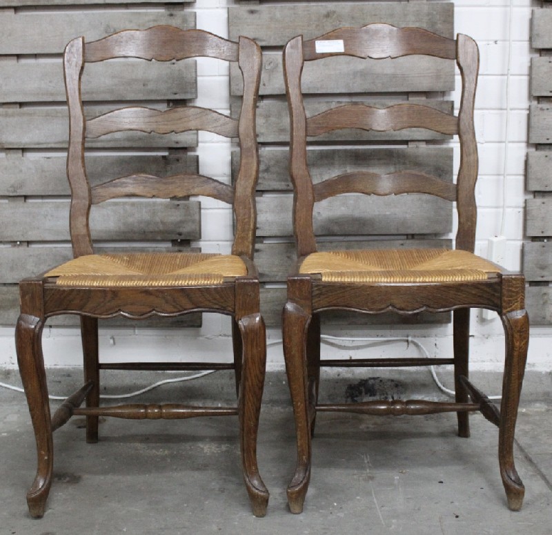 Set of six French provincial oak ladder back dining chairs with rush seats.