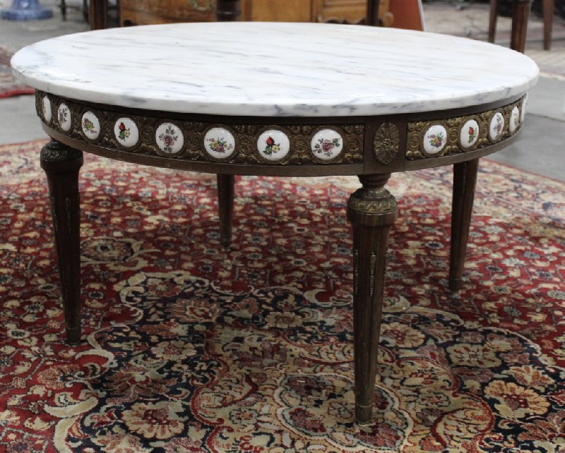 French walnut circular coffee table with white marble top and having Limoges porcelain panels to the side.