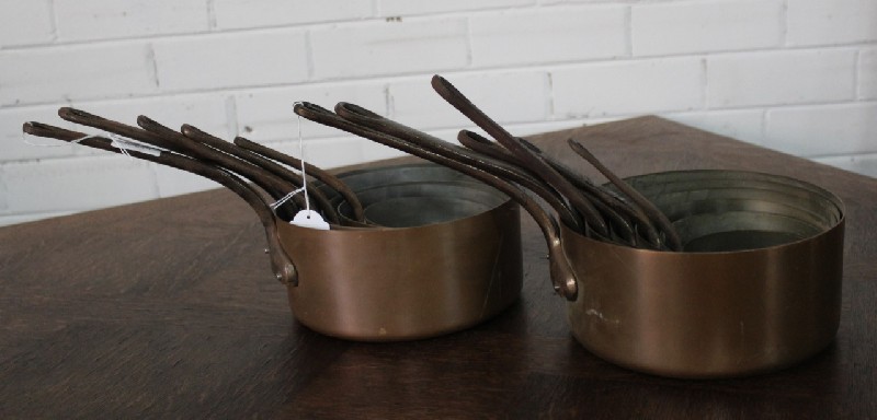 Sets of antique French copper saucepans.