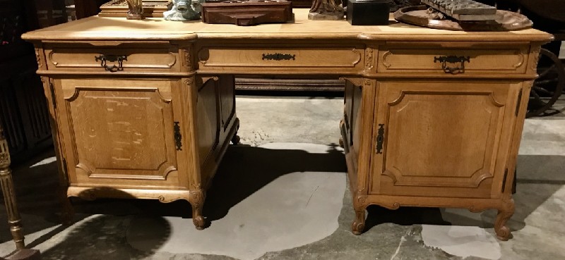 French provincial oak twin pedestal writing bureau fitted with drawers.