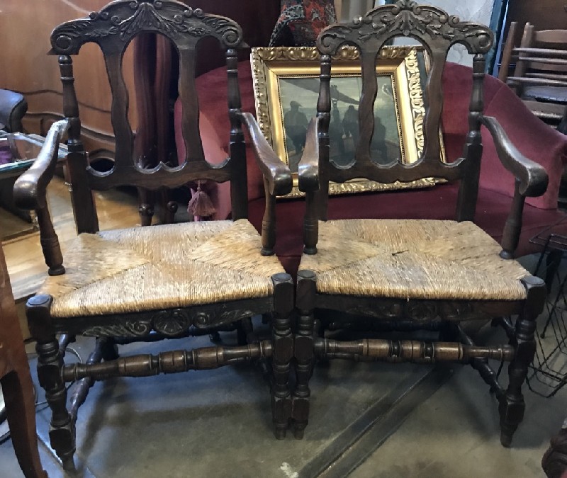Pair of French provincial oak and rush seated arm chairs.
