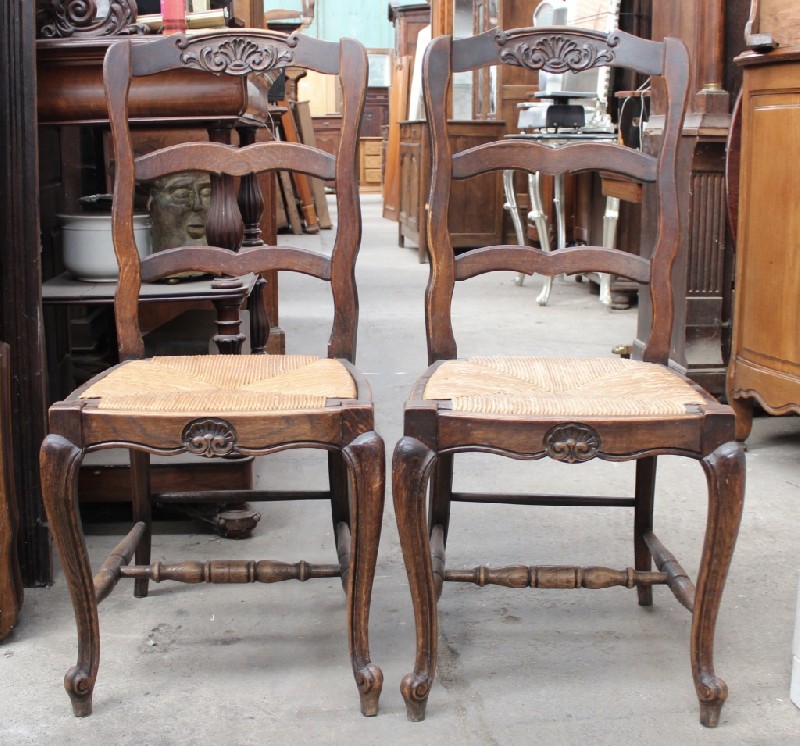 Set of six French provincial oak ladder back dining chairs with rush seats. Price $1200 set.