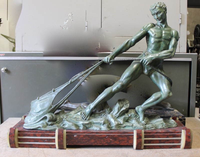 Fine French art deco male statue of a male pulling a fishing net on rouge marble base, signed Camus. Price $1800.