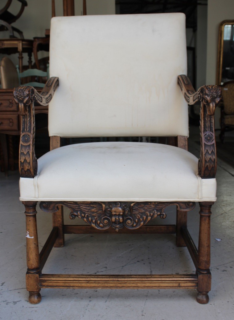 Fine 19th century French walnut fauteuil arm chair, having rams head arms and cupid carved front. Price $725