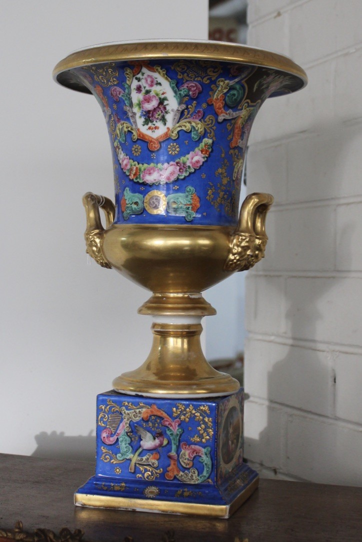 French late 19th century blue porcealin vase on stand, having floral panels and gilded handles and rim. Price $650