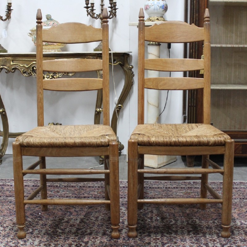 Set of 6 French provincial oak ladder back chairs with drop in rush seats. Price $880 set.
